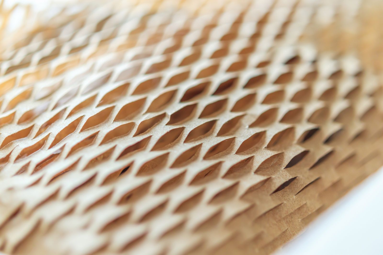 Close-up of brown honeycomb paper wrap stretched open into small diamond-shaped cells